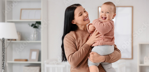Happy young mother holding ...