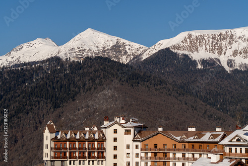Mountains, RosaKhutor, Sochi: Winter Snowcapped Peaks above Resort Buildings.
