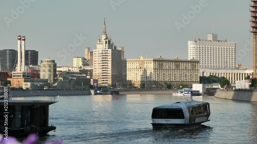 Moscow cityscape with Government House, Moskva River, and modern electric riverboat