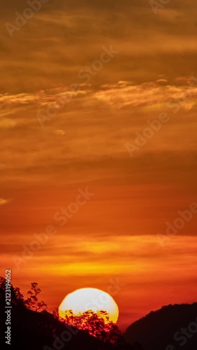 Mountain sunrise time-lapse with flowing mist and morning light hitting the ridges.