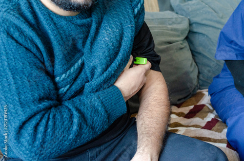 Cuadro en lienzo Close up of male patient measuring body temperature with digital thermometer