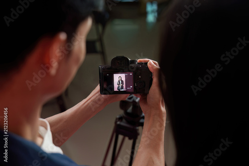 Camera screen showing model preview during photo shoot in studio