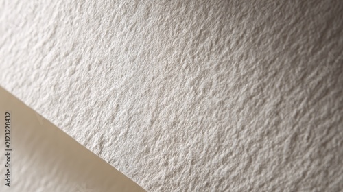 84.High-resolution close-up of white paper surface with subtle grain and fine fibers visible, soft natural lighting creating gentle shadows, realistic texture ideal for background or mockup use,