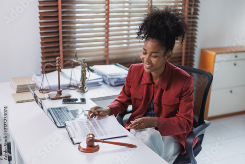 Female lawyer signing contract document in office