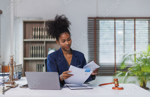 African american woman lawyer reviewing legal documents in office