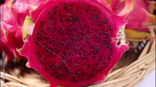 Close-up of fresh red dragon fruits arranged in a natural woven basket. The image highlights the vibrant red skin, unique texture, and tropical appearance of the fruit, making it ideal for healthy eat