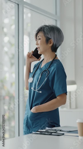 Female doctor takes personal call from family in hospital during downtime
