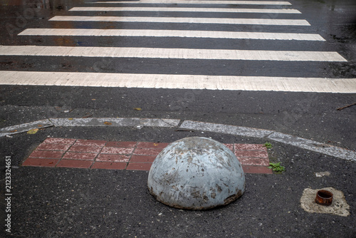 Hemispherical block in front of zebra marking on a summer day