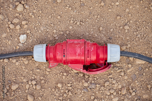 Fotografie Industrial power cable connector lying on the ground
