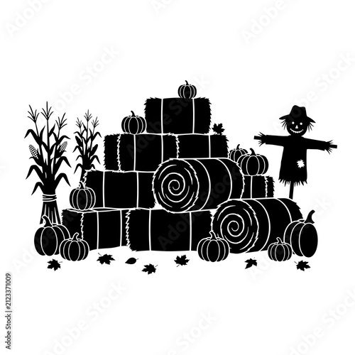 Harvest display silhouette with hay bales pumpkins and a scarecrow.