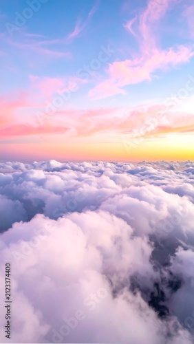 A serene aerial view of clouds at sunrise with vibrant pink and orange hues