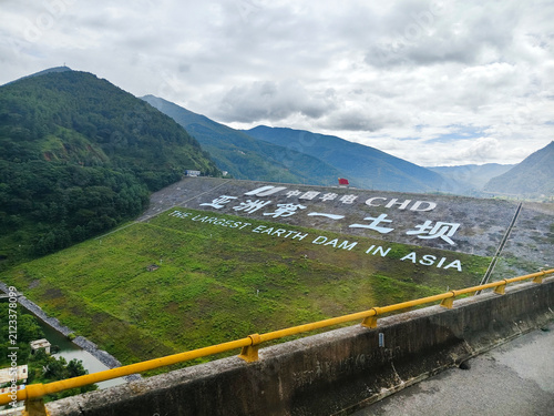 Scenic embankment dam structure with English and Chinese text 
