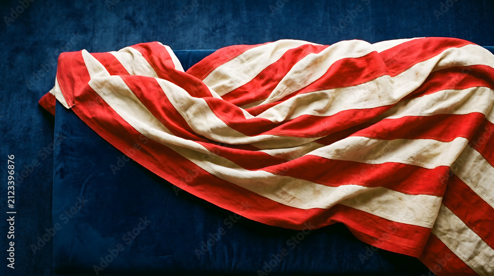Fototapeta premium Draped Red and White Striped Fabric Banner on Deep Blue Velvet Background