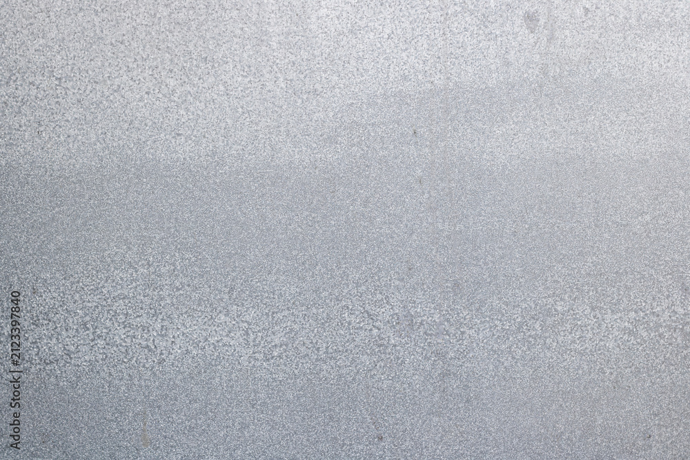 Fototapeta premium Flat textured surface background of a galvanized steel metal sheet with fine silver zinc spangle grain patterns for industrial design projects. High Quality Photo