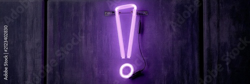 Vibrant Purple Neon Exclamation Mark on Dark Textured Wall