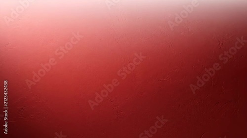 Deep Red Rough Plaster Wall Texture Backdrop Illuminated by Soft Light for Dramatic Background Design.