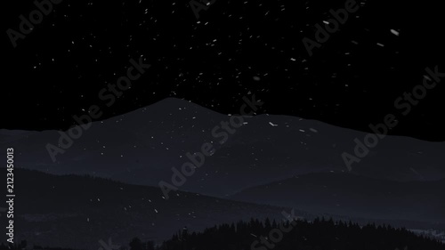 Snow is falling against the backdrop of mountains and a black background