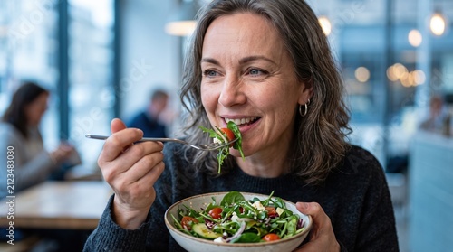 Mature woman enjoying a fresh healthy salad in a restaurant