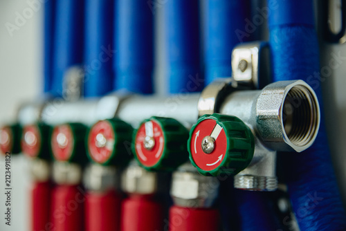 Bild auf Leinwand Heating manifold system with red and blue pipes installed during house renovation, representing home utility upgrade