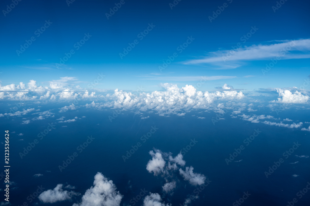 Fototapeta premium Aerial view of fluffy clouds over the Pacific Ocean in Polynesia