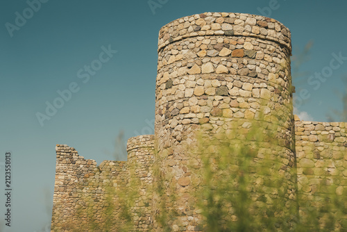 Konstfotografi Historic Noushirvan Caravanserai in Semnan Province, Iran, featuring massive circular stone towers and fortified masonry walls