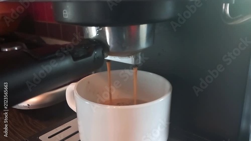 Espresso Machine Pump Hum with Liquid Flow, Ending with Rotary Switch Disengagement Click -- Close-up on Portafilter and Cup During Brew Cycle
