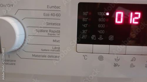 Door Slam Lock, Cycle Start Hum -- Close-up on Washing Machine Control Panel During Activation