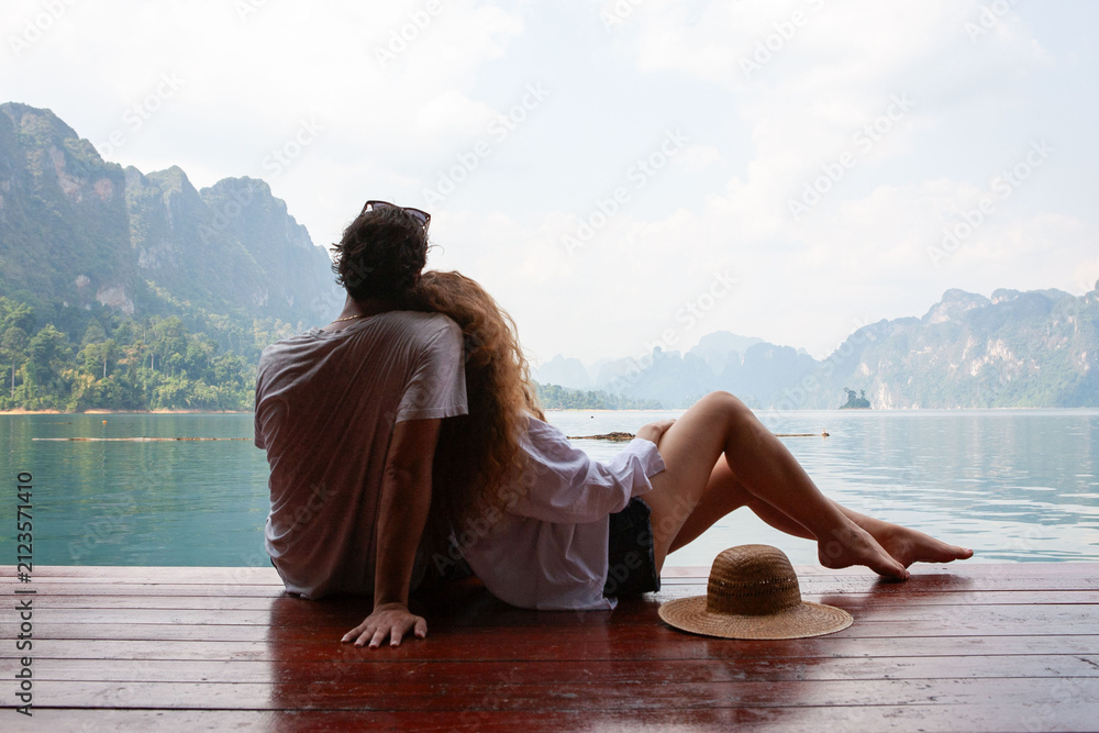 Fototapeta premium Couple relaxing by serene lake.