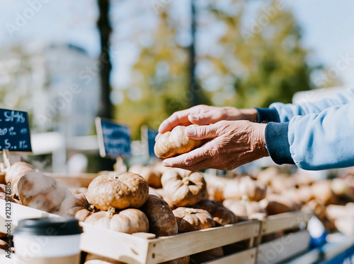 Hand Picking Up Fresh Pastry at Outdoor Bakery Market Stall in Daylight