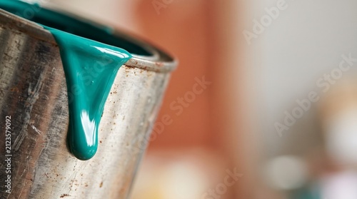 Teal Paint Dripping Down A Metal Can