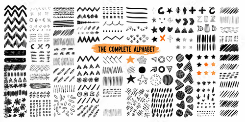фотографія Hand drawn brush stroke alphabet and decorative elements on white background