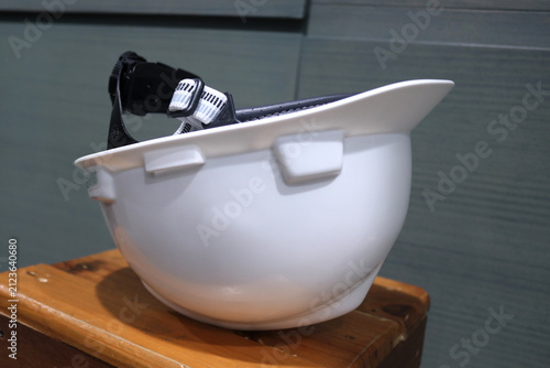A photo of a white safety helmet designed to protect workers' heads from workplace accidents.
