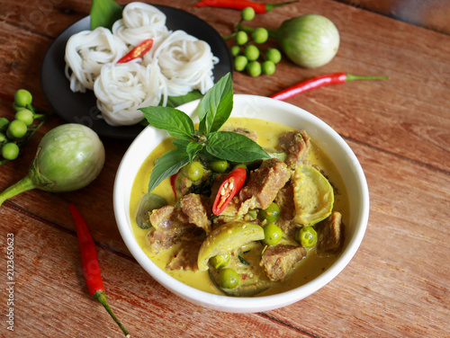 Beef green curry with eggplant, chili and basil serve with rice noodle. Authentic Thai food.