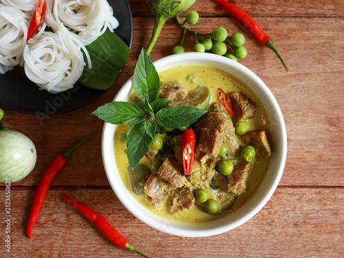 Beef green curry with eggplant, chili and basil serve with rice noodle. Authentic Thai food.