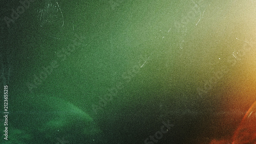 Vintage film grain texture with glowing green and orange light leaks. Abstract distressed background with dust and scratches for a retro analog aesthetic
