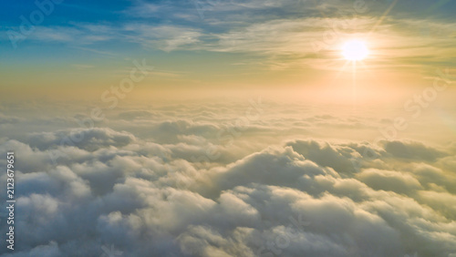 Photography Magnificent sunrise above a vast sea of clouds, with golden sunlight streaming a