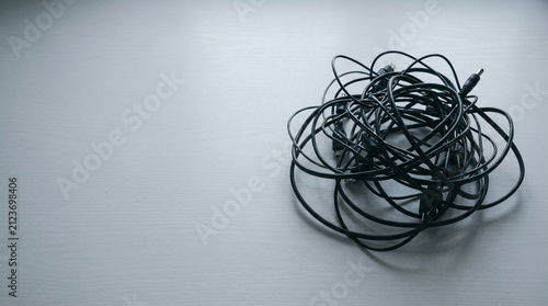 Wires and Cables Tangled on a White Table for Tech Organization