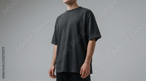 Man in Blank Black Oversized T-shirt Mockup on Gray Background