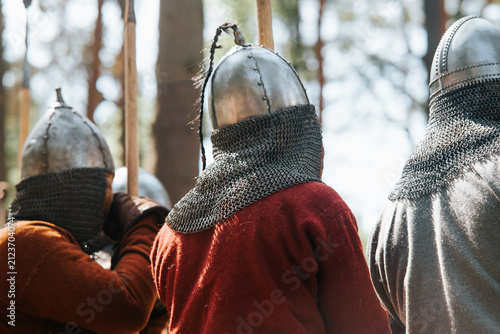Konstfotografi Four individuals, dressed in traditional medieval clothing and wearing metal hel
