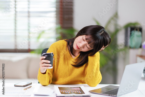 Obraz na plátne Young asian woman feeling tired, exhausted, and experiencing burnout while worki