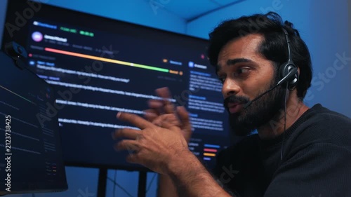 Concentrated Professional Indian Male Businessman with headset, Support Agent Helping Customer Solve Technical Problem Communication Remote Assistance, Help Desk At Call Center Office.