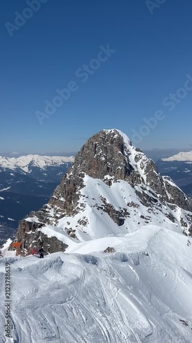 Skiers at the peaks of French alps by winter under snow 