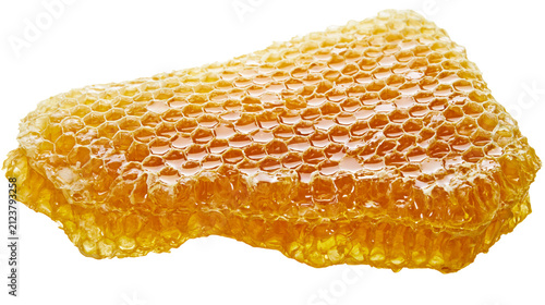 Konstfotografi Golden honeycomb chunk filled with sweet liquid honey, isolated on transparent b