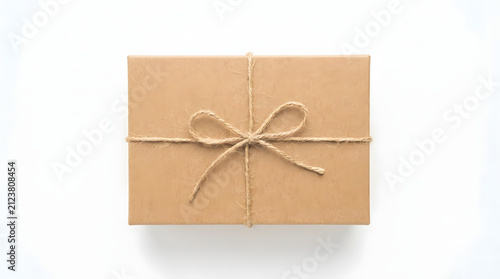 Parcel box wrapped in brown craft paper with rustic twine rope bow isolated on white space.