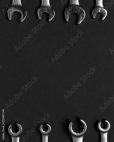 Fotografía Wrenches arranged in borders on dark background