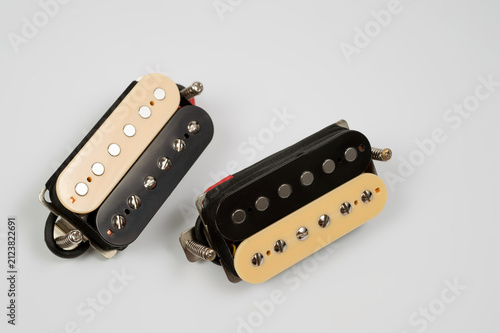 A set of electric guitar pickups, close-up shot on a white background.