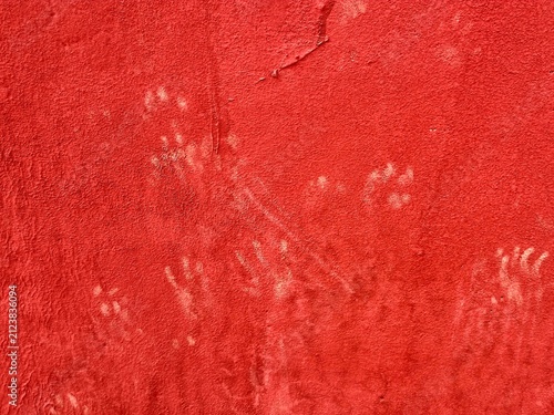 Dusty Cat Paw Prints on Red Painted Wall Texture Background
