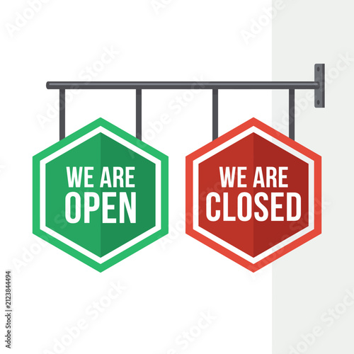 Green open and red closed hexagonal signs hanging on a metal bar
