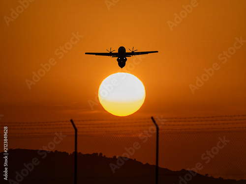 Photograph of commercial airplanes photographed at sunset