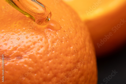 pipette with vitamin C on orange